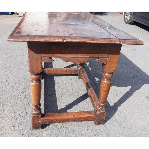 572 - An antique oak Refectory Table in the 17th Century style with moulded top above a shaped and channel... 