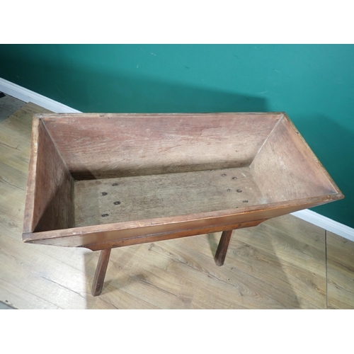 579 - An early 19th Century elm Dough Bin of tapering form with shaped frieze on chamfered squared support... 