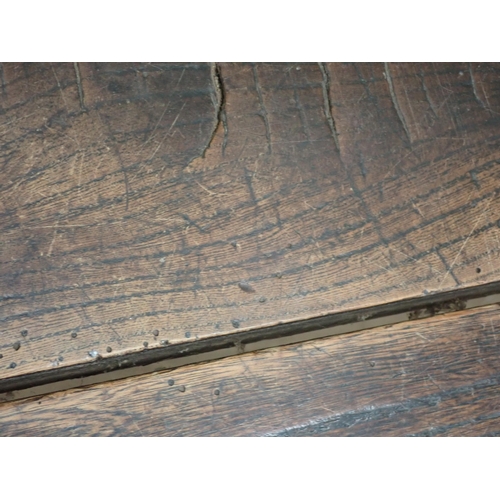 580 - An 18th Century elm Refectory Table with three-plank top, with moulded frieze and raised on squared ... 