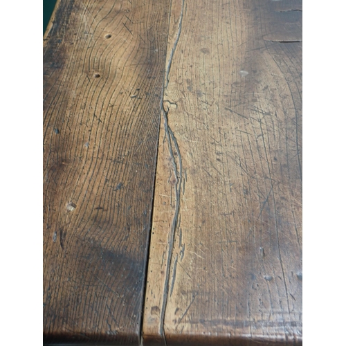 580 - An 18th Century elm Refectory Table with three-plank top, with moulded frieze and raised on squared ... 