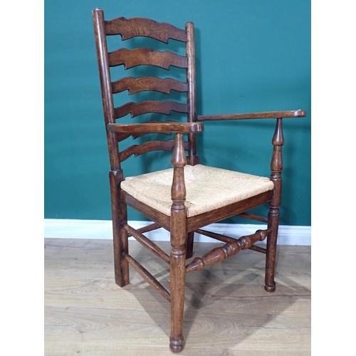 595 - A set of six oak ladderback Dining Chairs with rush seats on turned supports and stretchers; two car... 