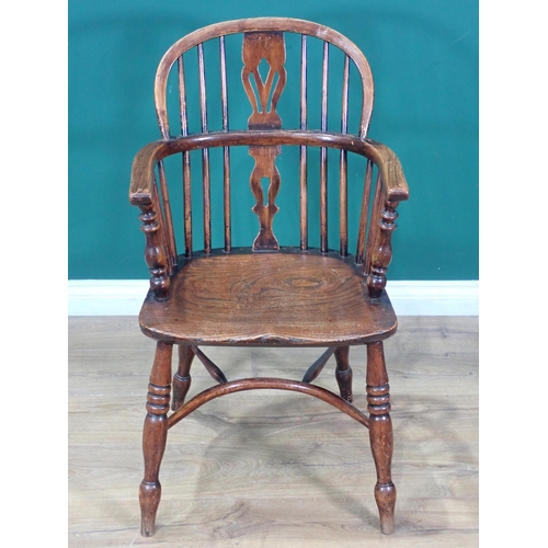 608 - A 19th Century ash and elm Windsor Elbow Chair with pierced splat back mounted upon turned supports ... 