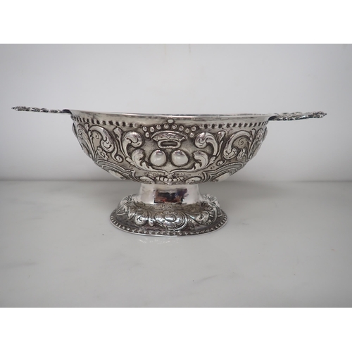 61 - An 18th Century Dutch silver oval Brandy Bowl with lobed and scroll embossing, flat pierced handles ... 