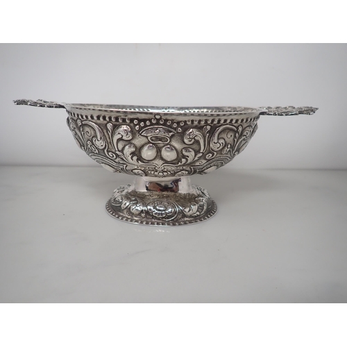 61 - An 18th Century Dutch silver oval Brandy Bowl with lobed and scroll embossing, flat pierced handles ... 