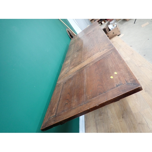 623 - An antique oak draw-leaf Table utilising 17th Century and later timber with leafage carved frieze an... 