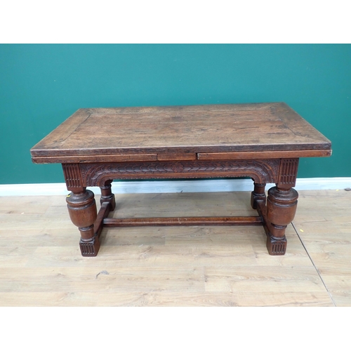 623 - An antique oak draw-leaf Table utilising 17th Century and later timber with leafage carved frieze an... 