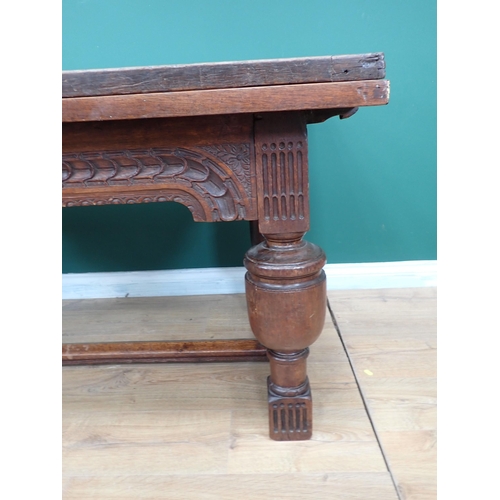 623 - An antique oak draw-leaf Table utilising 17th Century and later timber with leafage carved frieze an... 