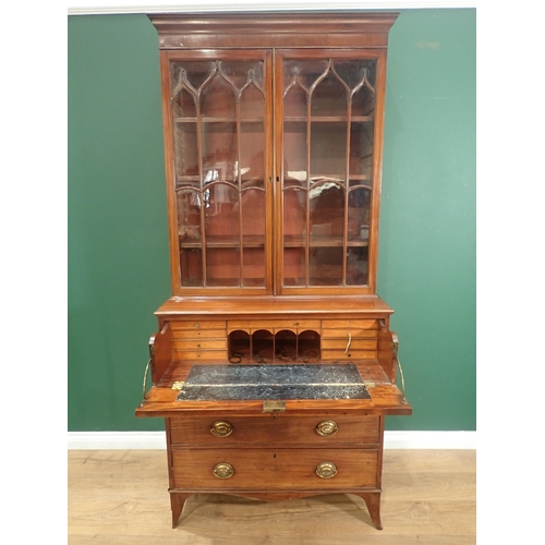 635 - An early 19th Century mahogany Secretaire Bookcase, the fitted drawer with oval inlaid decoration, o... 