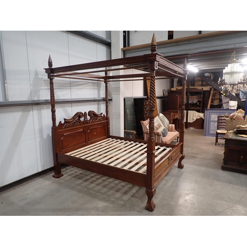 642 - A reproduction four poster Bed with scrolled carved and panelled headboard, spiral turned and carved... 