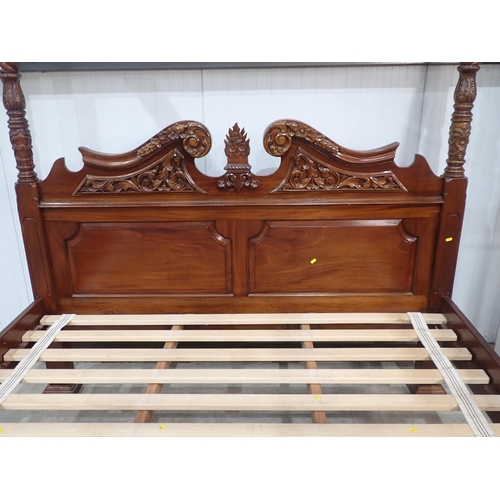 642 - A reproduction four poster Bed with scrolled carved and panelled headboard, spiral turned and carved... 