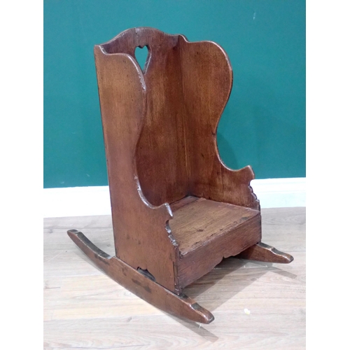 644 - An antique oak child's Rocking Chair with pierced heart shape to panel back 2ft 1in H x 1ft 3in W