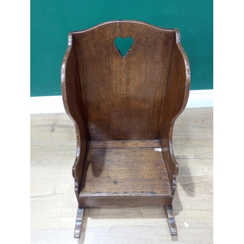 644 - An antique oak child's Rocking Chair with pierced heart shape to panel back 2ft 1in H x 1ft 3in W