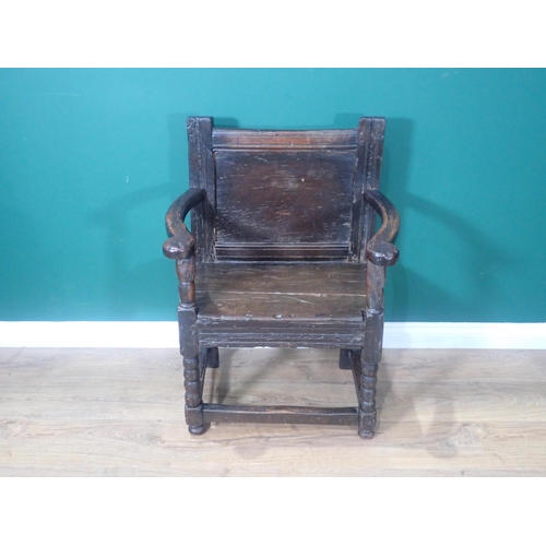 648 - A 17th Century and later oak Armchair with plain panelled back, shaped arms, solid seat, on bobbin-t... 