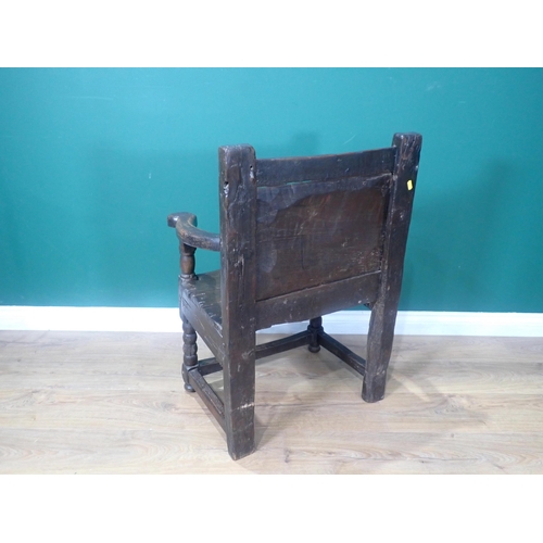 648 - A 17th Century and later oak Armchair with plain panelled back, shaped arms, solid seat, on bobbin-t... 