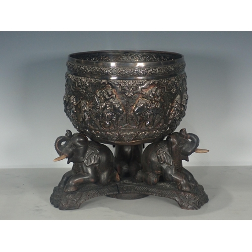 65 - A large 19th Century Burmese silver Thabeik Bowl, decorated with high relief repousse scene of mytho... 