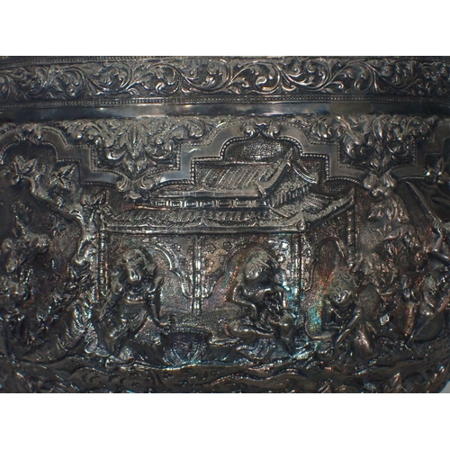 65 - A large 19th Century Burmese silver Thabeik Bowl, decorated with high relief repousse scene of mytho... 