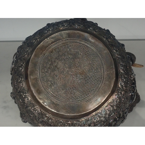 65 - A large 19th Century Burmese silver Thabeik Bowl, decorated with high relief repousse scene of mytho... 