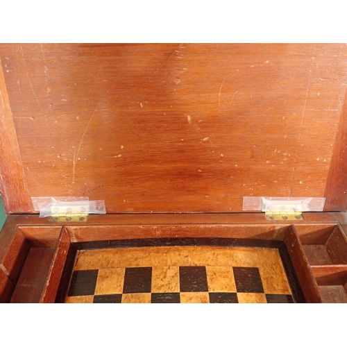 650 - A 19th Century Games/Work Table with hinged cover opening to reveal a games board and raised on squa... 