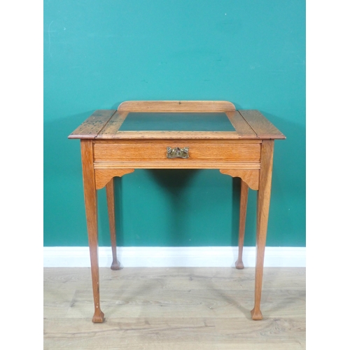 658 - An Edwardian oak Writing Table with slide out writing surface, frieze drawer on shaped square taperi... 