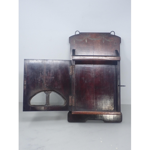 660 - A 19th Century Letter Rack with painted swag decoration and fitted cupboard door with two glazed pan... 