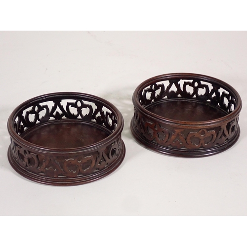 666 - A pair of mahogany pierced circular Wine Coasters A/F.