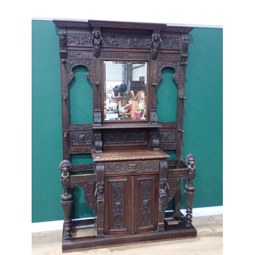 681 - An impressive Victorian carved oak breakfront Hallstand with scroll carved frieze with lion and figu... 