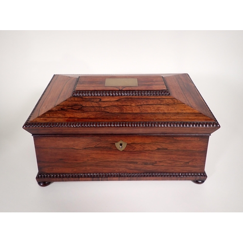 683 - A Victorian rosewood Tea Caddy of sarcophagus shape with two interior lidded boxes, on bun feet, 13i... 