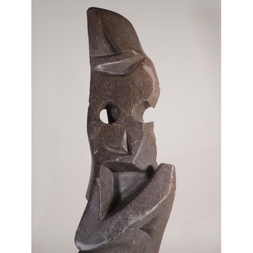 693 - A large Inuit hardstone Carving of a figure in stylised form with pierced and carved detail, 2ft 9in