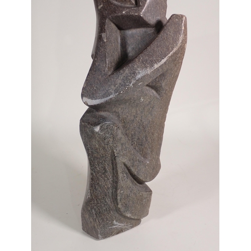 693 - A large Inuit hardstone Carving of a figure in stylised form with pierced and carved detail, 2ft 9in