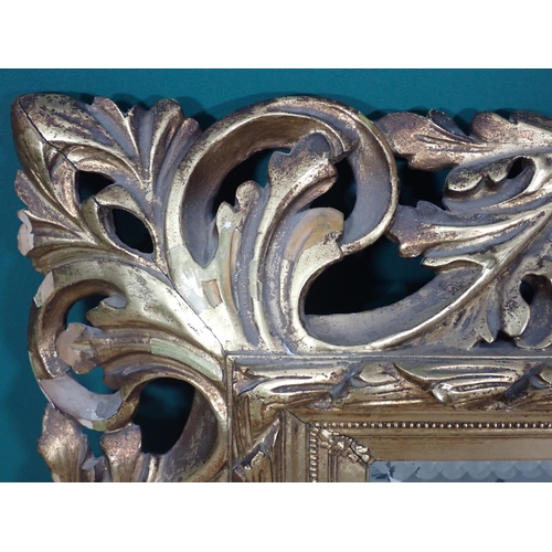 708 - A gilt Wall Mirror with elaborate scrolled foliate frame, 3ft 10in H x 2ft 11in W