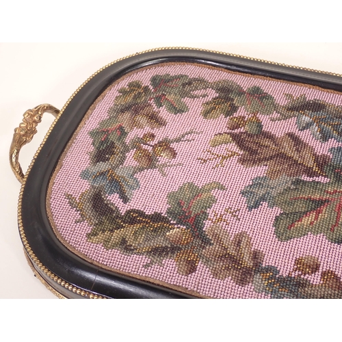 711 - A 19th Century beadwork Tray with ebonised and beaded frame and two gilt metal handles 2ft W