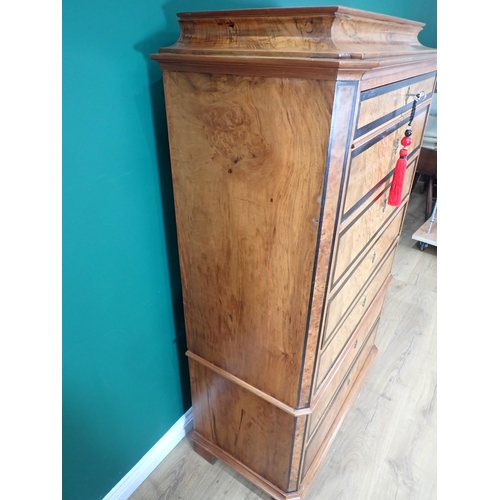 730 - A 19th Century Biedermeier Chest in walnut with shaped surmount above seven crossbanded graduated dr... 