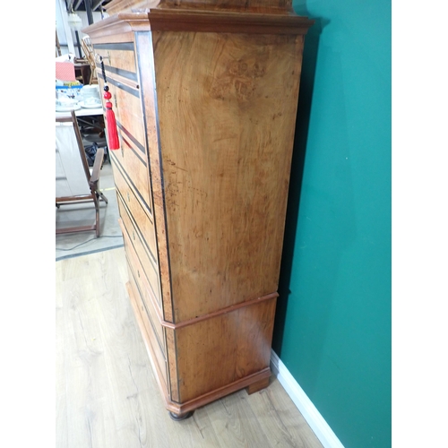 730 - A 19th Century Biedermeier Chest in walnut with shaped surmount above seven crossbanded graduated dr... 