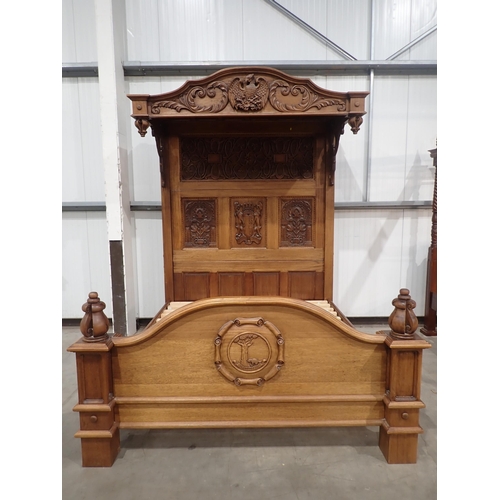 731 - A large bespoke made half-tester Bed bearing carved coat of arms to the panelled back flanked by car... 