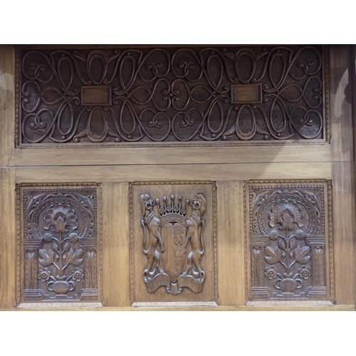 731 - A large bespoke made half-tester Bed bearing carved coat of arms to the panelled back flanked by car... 