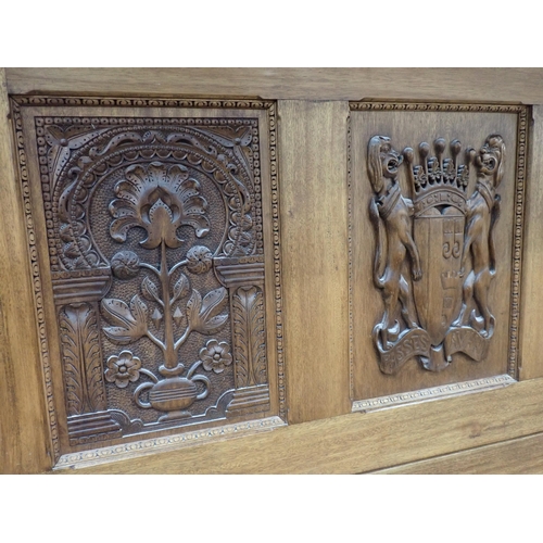 731 - A large bespoke made half-tester Bed bearing carved coat of arms to the panelled back flanked by car... 