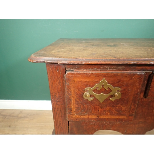 736 - An 18th Century oak Lowboy with moulded and feather banded top above three drawers and shaped frieze... 