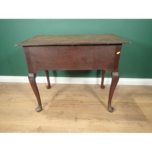 736 - An 18th Century oak Lowboy with moulded and feather banded top above three drawers and shaped frieze... 