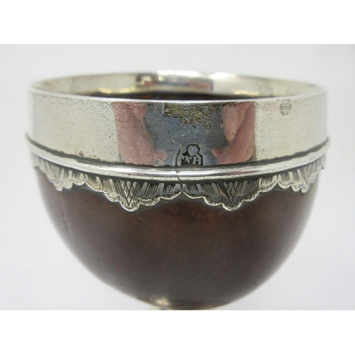 80 - An early silver mounted Coconut Cup with shallow engraved frieze to the rim, engraved initials, 6in,... 