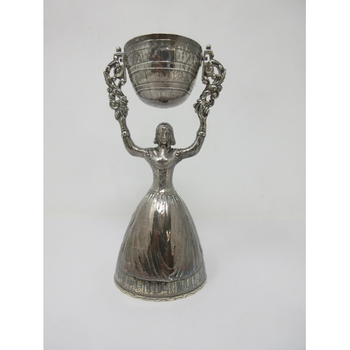 87 - A George V silver Wager Cup in the form of a woman supporting swivel cup, London 1910 maker: F.H. & ... 