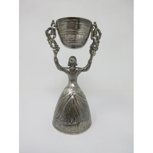 87 - A George V silver Wager Cup in the form of a woman supporting swivel cup, London 1910 maker: F.H. & ... 