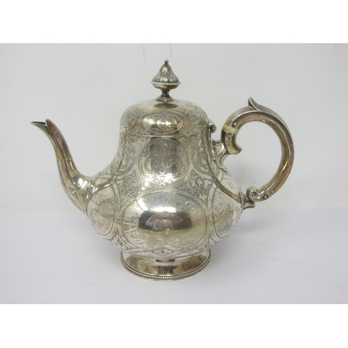 92 - A Victorian silver Teapot of pear shape with lightly engraved cartouches and crest, on beaded circul... 