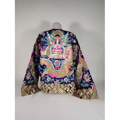 502 - A late 19th/early 20th Century Chinese blue silk Jacket, embroidered gold and polychrome dragon, flo... 