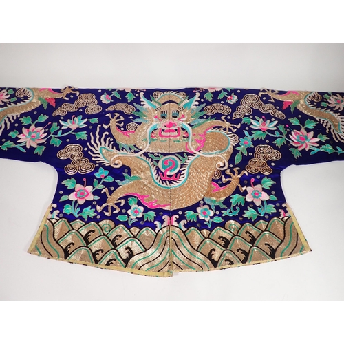 502 - A late 19th/early 20th Century Chinese blue silk Jacket, embroidered gold and polychrome dragon, flo... 