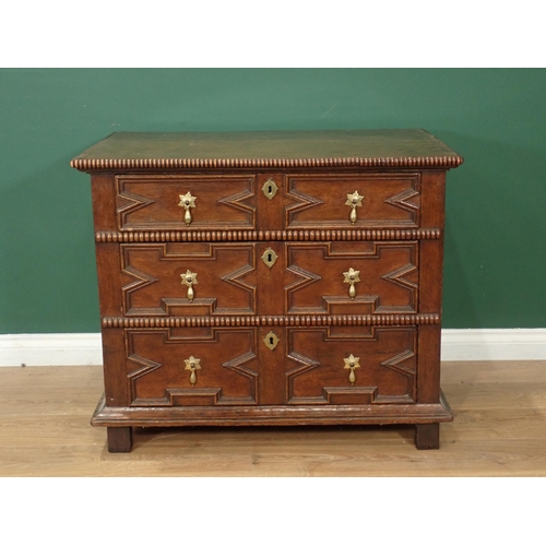 690 - A 17th Century-style oak Chest, the top and front with gadroon mouldings, fitted three geometric mou... 