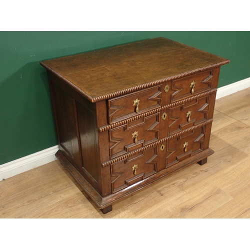 690 - A 17th Century-style oak Chest, the top and front with gadroon mouldings, fitted three geometric mou... 