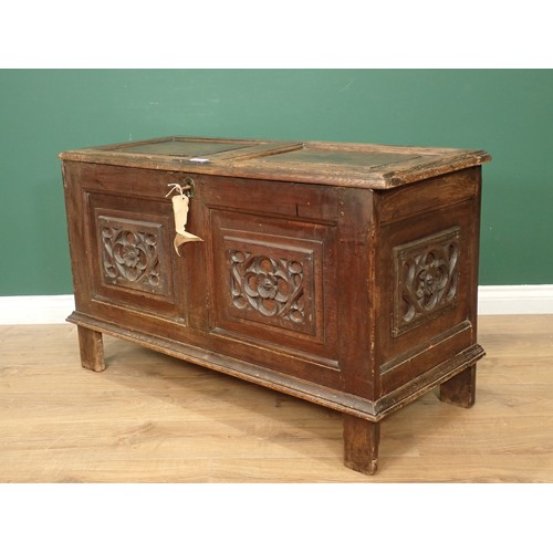 567 - A 17th Century oak Coffer with sunken two panel lid above two earlier tracery carved rosette front p... 