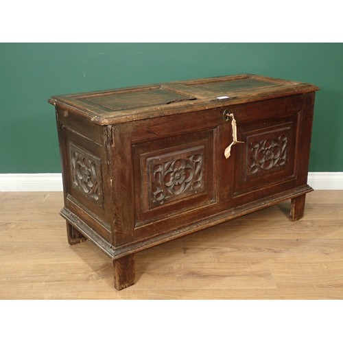 567 - A 17th Century oak Coffer with sunken two panel lid above two earlier tracery carved rosette front p... 