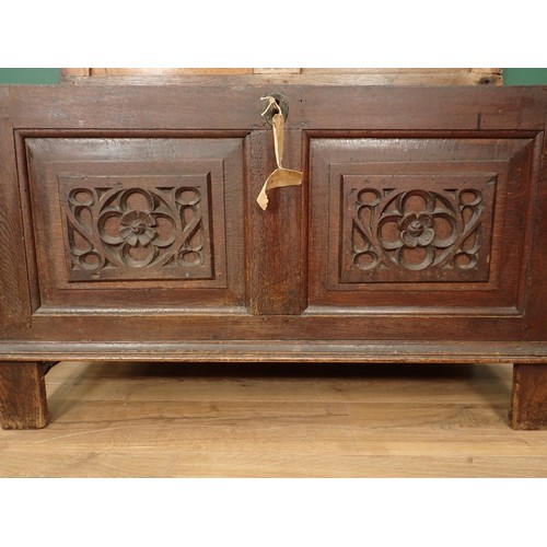 567 - A 17th Century oak Coffer with sunken two panel lid above two earlier tracery carved rosette front p... 