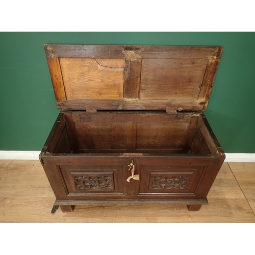 567 - A 17th Century oak Coffer with sunken two panel lid above two earlier tracery carved rosette front p... 